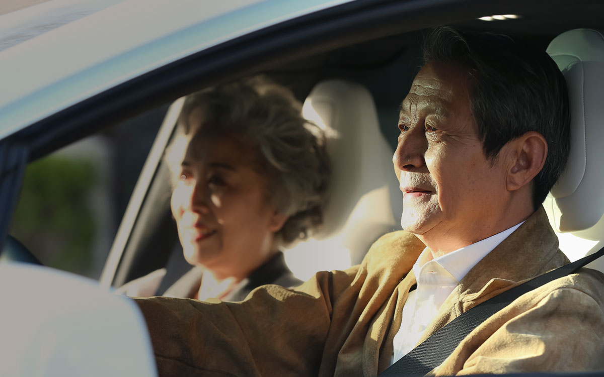 Older couple in the car, man is driving Older couple in the car, man is driving