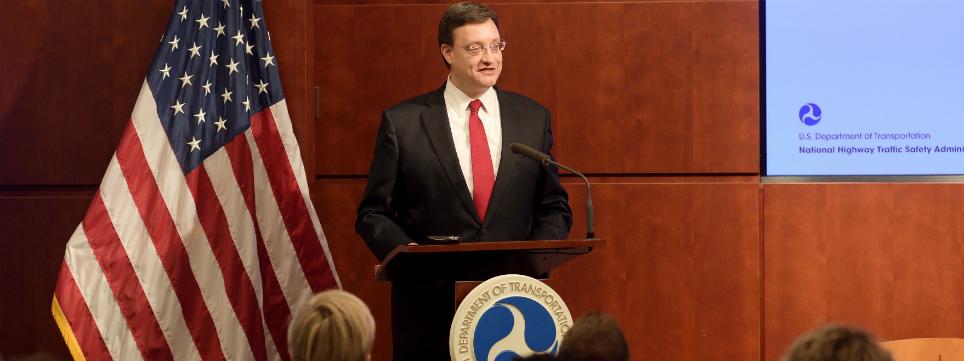 James Owens speaking at a podium James Owens speaking at a podium