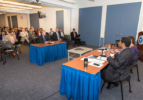 Photo of people watching a speaker.