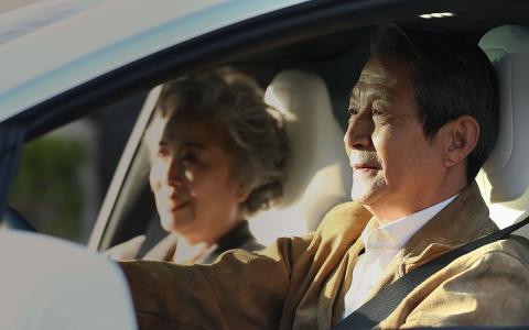 Older couple in the car, man is driving Older couple in the car, man is driving