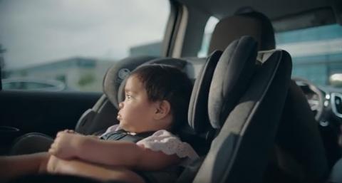 Child alone in car seat in car