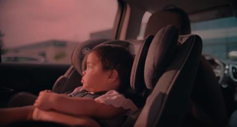 Child alone in car seat in car