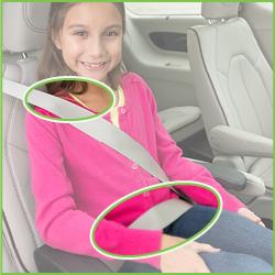 Child in booster seat, focus on seat belt positioning