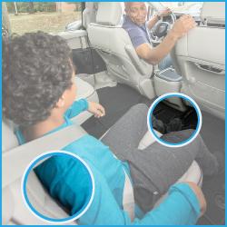 Child wearing a seat belt in back seat