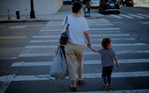 Woman and child crossing a street