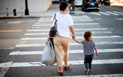 Woman and child crossing a street Woman and child crossing a street