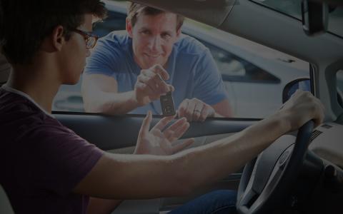 Teen driver in car, father handing him keys Teen driver in car, father handing him keys
