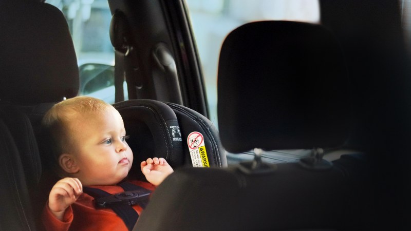 baby in a car seat in a car