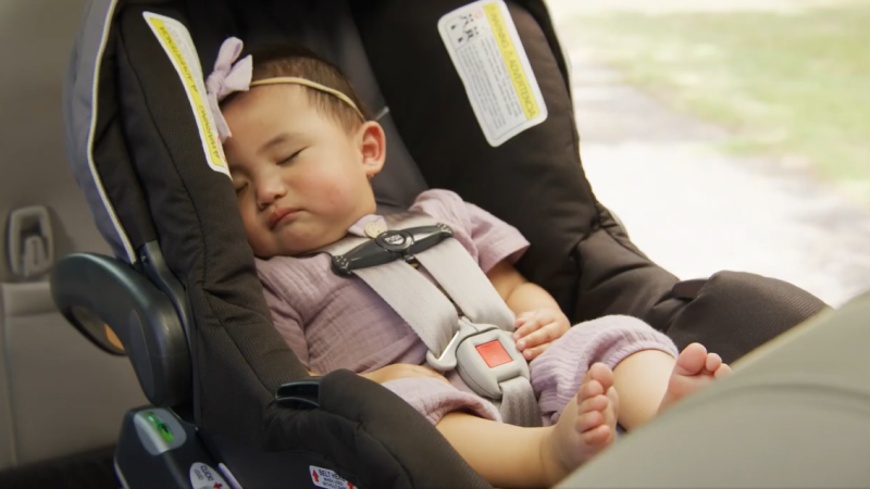 A photo of a child in a rear-facing car seat.